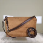Couple Tote Camel suede shoulder bag with detachable crossbody strap, minimalist design, and spacious zippered compartment.