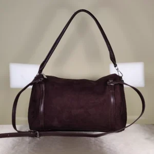 Brown suede shoulder and crossbody bag with adjustable strap.