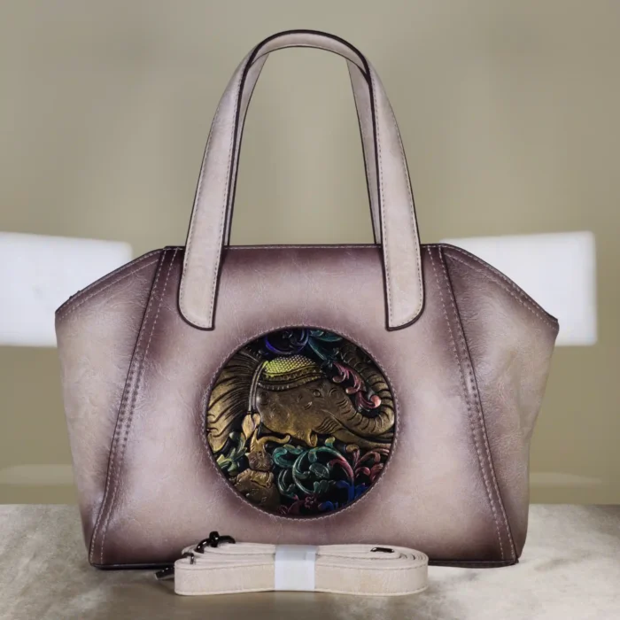 Women's metallic taupe tote handbag with artistic elephant design and detachable sling strap
