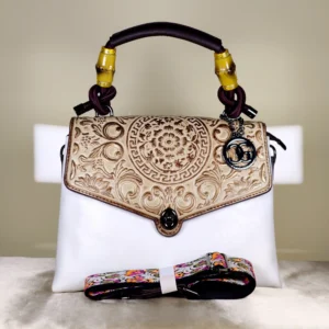 IMG_20260820_124819 Ivory embossed top handle satchel bag with handle, a floral flap design, and detachable printed shoulder strap.