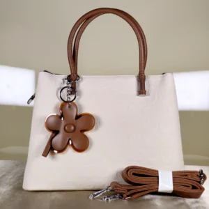 IMG_20260820_125849 Ivory textured top handle satchel handbag with tan handles, detachable shoulder strap, and floral charm for women