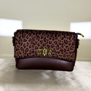Women's leopard print flap crossbody sling bag with twist-lock closure and adjustable shoulder strap