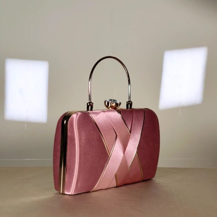 A sophisticated structured clutch bag featuring an elegant rectangular silhouette, decorative overlapping front detailing, and a sleek top handle. Perfect for adding a refined touch to evening and special-occasion outfits.