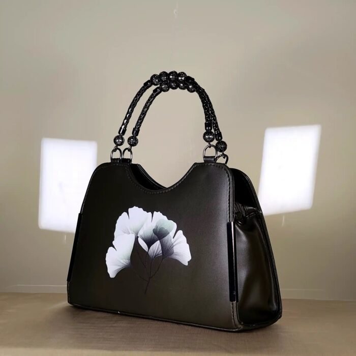 floral printed women's top handle handbag with a decorative beaded handle.