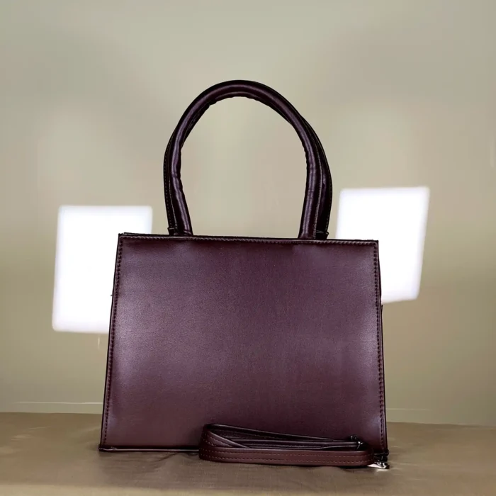 Burgundy patterned top handle tote bag with dark handles and detachable sling strap