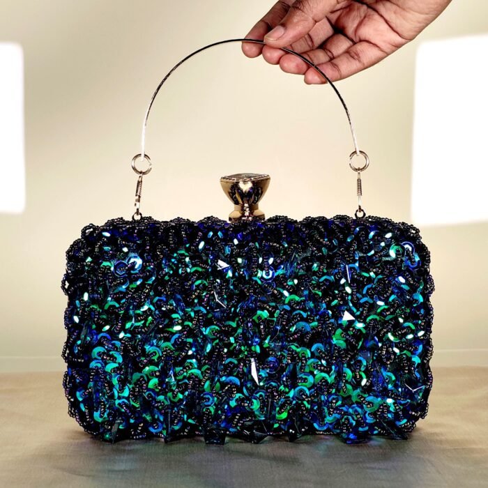 Blue crystal embellished evening clutch bag with gold frame and detachable chain strap