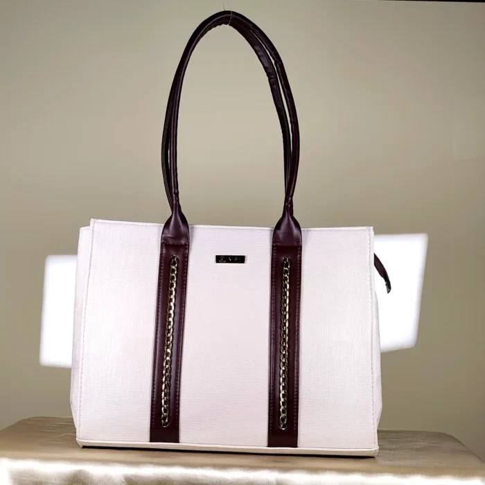 IMG_20260820_153244 Ivory and brown structured tote bag with gold-tone chain-detail handles