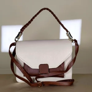 Ivory and brown structured flap top handle sling bag with braided handle and adjustable shoulder strap