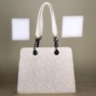 Ivory floral embossed top handle bag with black chain handles