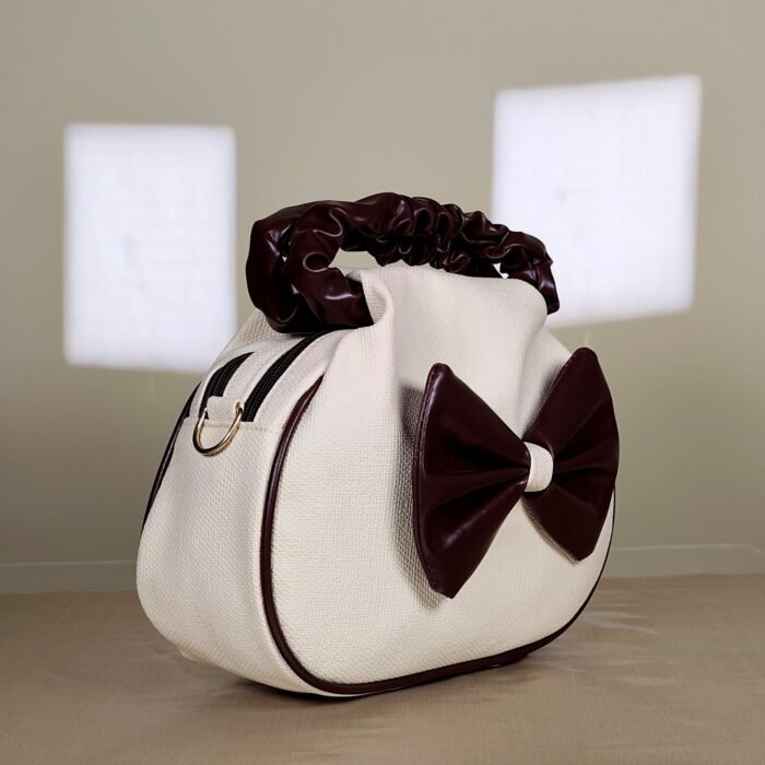 IMG_20260820_165805 Ivory shoulder bag with burgundy bow detail and ruched handle