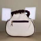 Ivory shoulder bag with burgundy bow detail and ruched handle