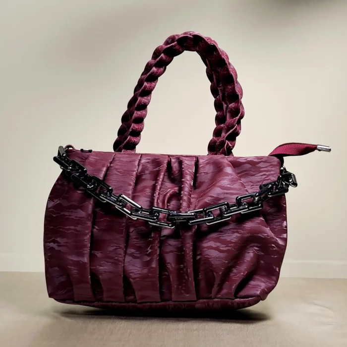 quilted top handle bag with braided handles and silver chain detailing