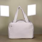 Quilted lunch bag with dual handles and zip closure