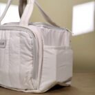 Quilted lunch bag with dual handles and zip closure